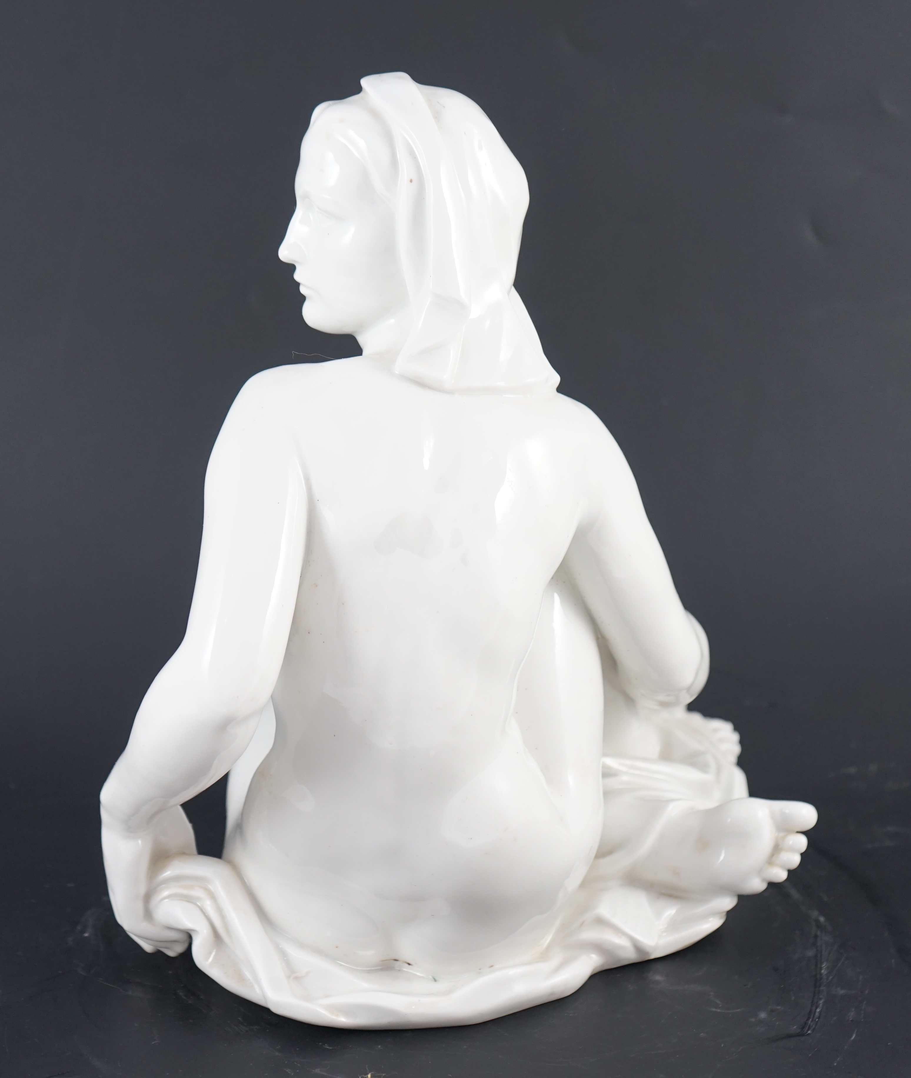 Robert Ullmann (1903-1966) for Meissen, a white glazed porcelain figure of a seated female nude, 31.5cm high